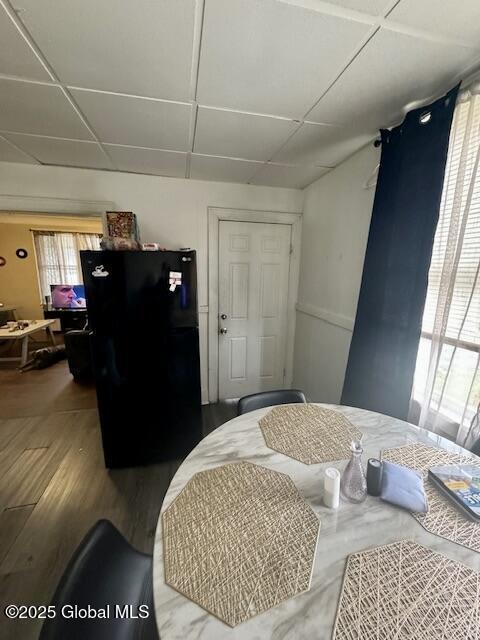11 Lefferts St, Amsterdam, NY 12010 - bedroom featuring freestanding refrigerator, multiple windows, and wood finished floors