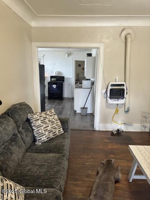 11 Lefferts St, Amsterdam, NY 12010 - living area featuring wood finished floors, heating unit, water heater, and baseboards