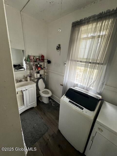 11 Lefferts St, Amsterdam, NY 12010 - bathroom with wood finished floors, washer and dryer, vanity, and toilet
