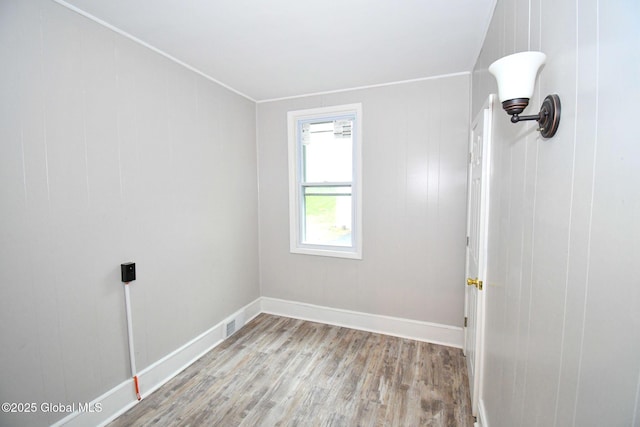 unfurnished room with light wood finished floors and baseboards