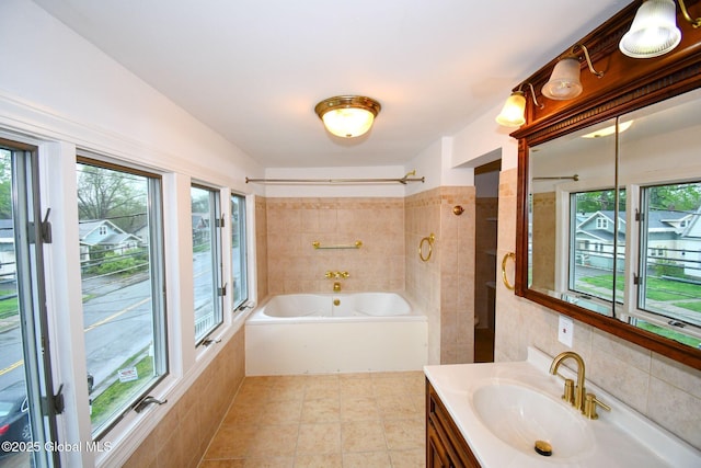 full bathroom featuring vanity, tile walls, a wealth of natural light, and  shower combination