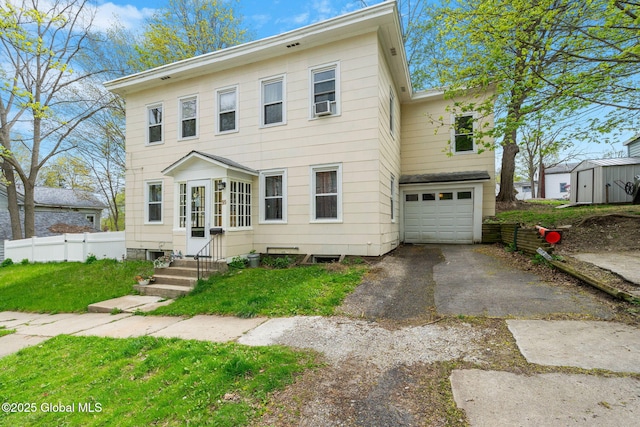 99 Otsego St, Canajoharie, NY 13317 - colonial home featuring asphalt driveway and an attached garage