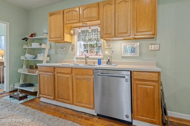 99 Otsego St, Canajoharie, NY 13317 - kitchen with stainless steel dishwasher, wood finished floors, and light countertops