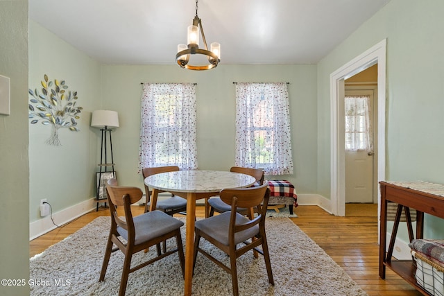 99 Otsego St, Canajoharie, NY 13317 - dining area with a chandelier, light wood finished floors, and baseboards