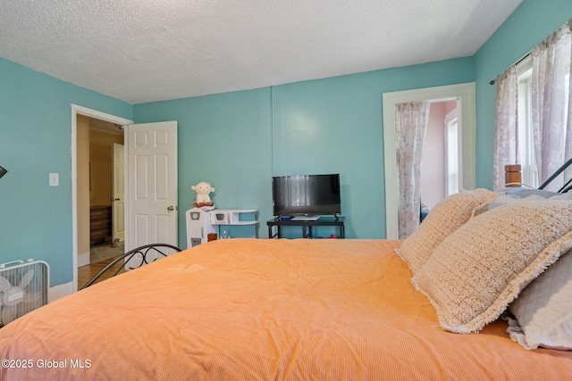 99 Otsego St, Canajoharie, NY 13317 - bedroom featuring a textured ceiling and baseboards