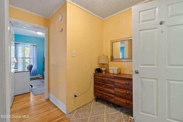 99 Otsego St, Canajoharie, NY 13317 - hallway featuring a baseboard radiator, a textured ceiling, and wood finished floors