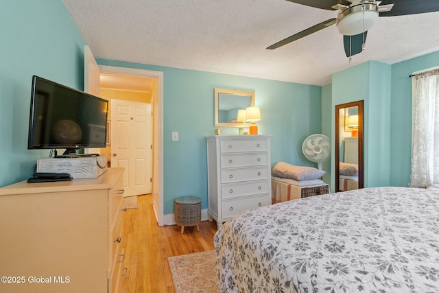 99 Otsego St, Canajoharie, NY 13317 - bedroom featuring light wood-style floors, a textured ceiling, baseboards, and ceiling fan