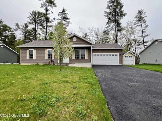 view of front of property featuring driveway, a garage, and a front lawn