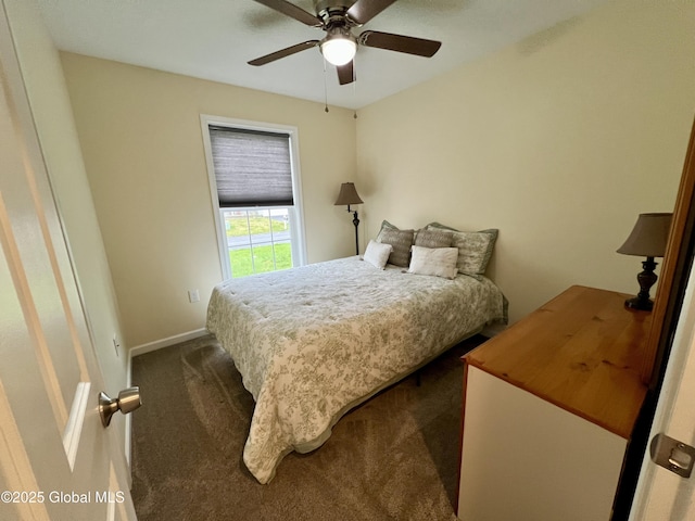 bedroom featuring dark carpet, baseboards, and a ceiling fan