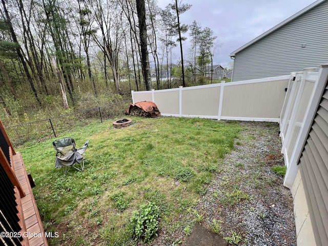 view of yard with a fire pit