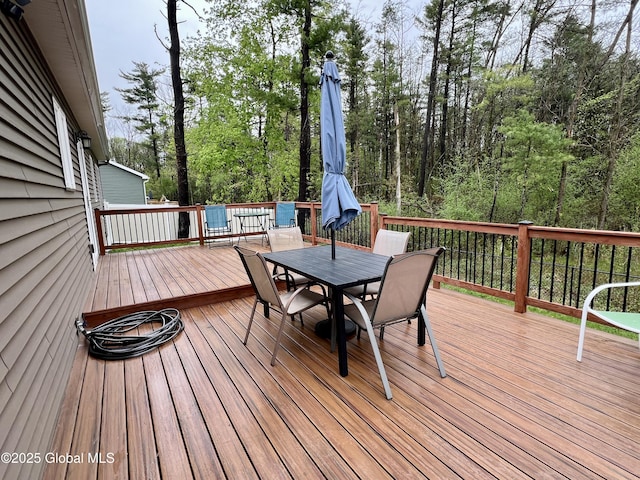 wooden deck with outdoor dining space