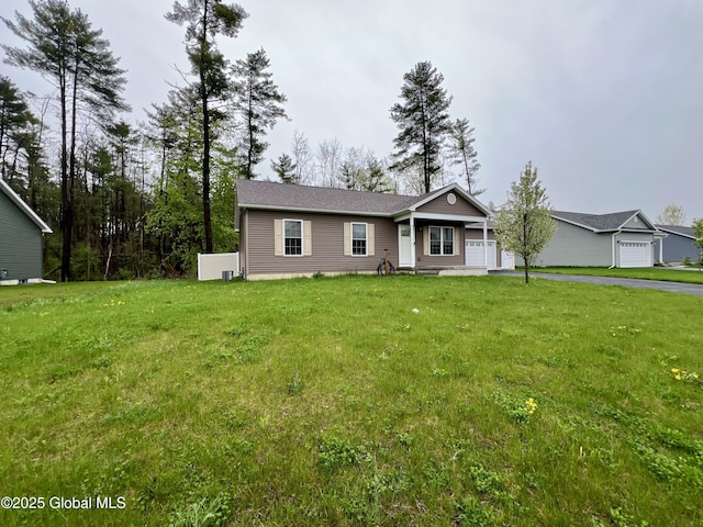 ranch-style home featuring an attached garage, a front yard, and asphalt driveway