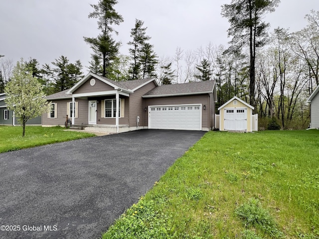 ranch-style home with an attached garage, driveway, a front lawn, a storage unit, and roof with shingles