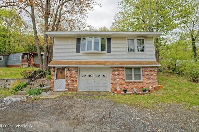 17-19 Smith Ct, North Greenbush, NY 12198 - view of front of home with a garage, brick siding, and driveway