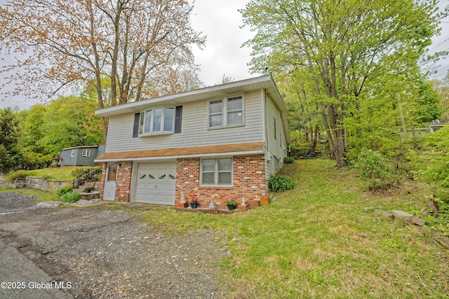 17-19 Smith Ct, North Greenbush, NY 12198 - view of front of house with brick siding, dirt driveway, an attached garage, and a front yard