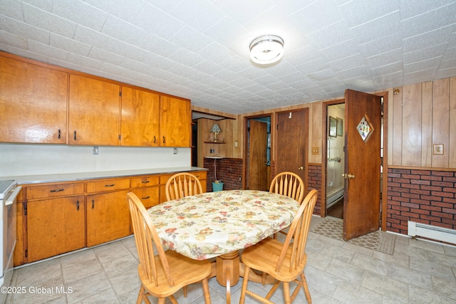 17-19 Smith Ct, North Greenbush, NY 12198 - dining space with baseboard heating, wood walls, and light stone finish flooring