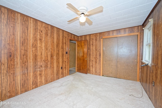 17-19 Smith Ct, North Greenbush, NY 12198 - unfurnished bedroom with wooden walls, carpet flooring, a closet, and ceiling fan