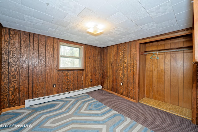 17-19 Smith Ct, North Greenbush, NY 12198 - empty room featuring a baseboard radiator, wooden walls, and carpet flooring