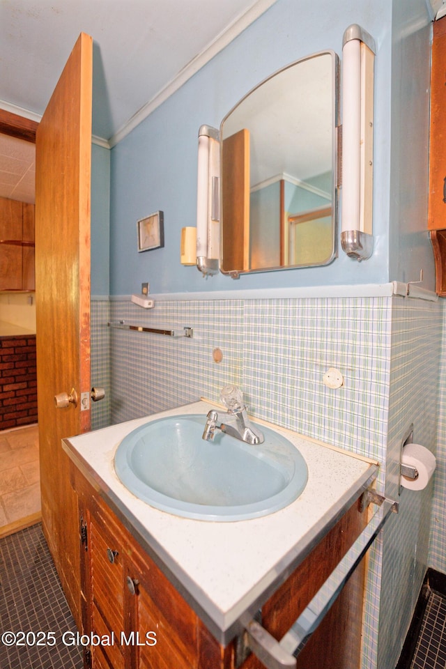 17-19 Smith Ct, North Greenbush, NY 12198 - bathroom with vanity, tile patterned floors, a wainscoted wall, tile walls, and ornamental molding