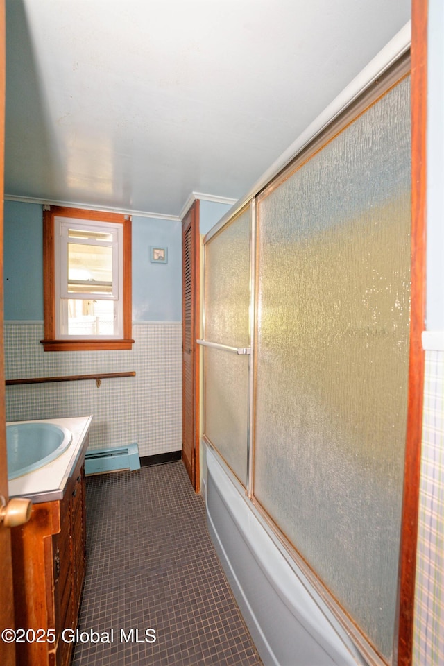 17-19 Smith Ct, North Greenbush, NY 12198 - full bath with a baseboard heating unit, vanity, bath / shower combo with glass door, tile patterned flooring, and a wainscoted wall