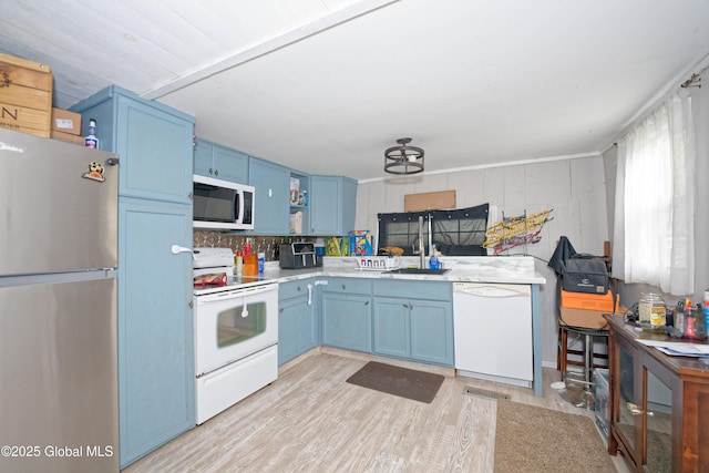 17-19 Smith Ct, North Greenbush, NY 12198 - kitchen with white appliances, blue cabinetry, light countertops, light wood-style floors, and open shelves
