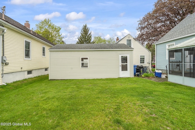 back of house featuring a yard