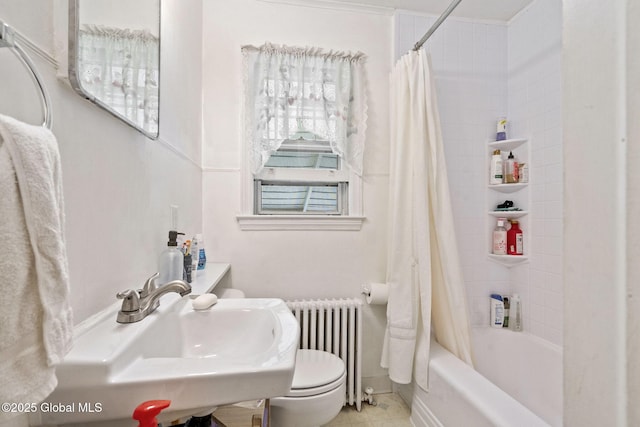 full bathroom with radiator, toilet, shower / tub combo with curtain, a sink, and tile patterned floors