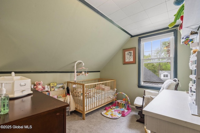 bedroom featuring lofted ceiling, carpet flooring, a nursery area, and baseboards