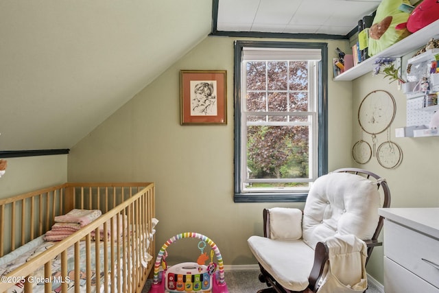 bedroom featuring a nursery area, vaulted ceiling, baseboards, and carpet flooring