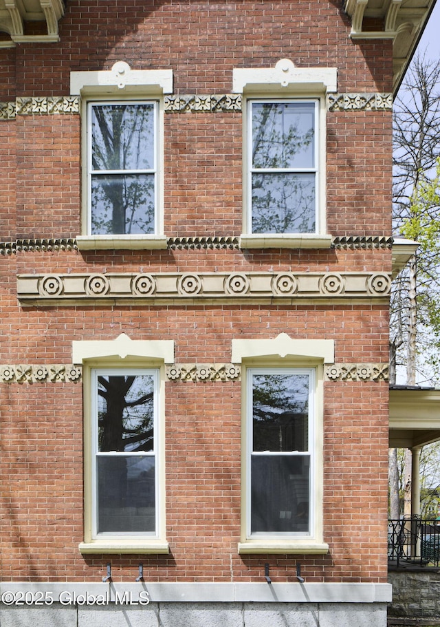 view of side of property featuring brick siding