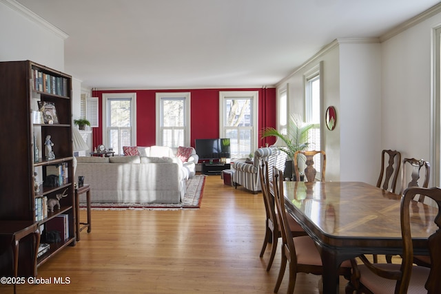 dining space with ornamental molding, a wealth of natural light, and wood finished floors