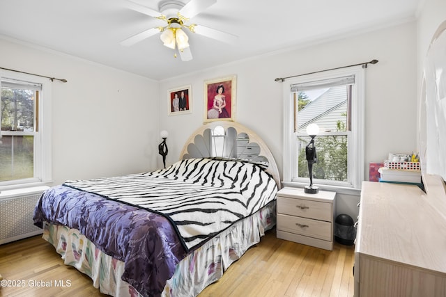 1834 Western Ave, Guilderland, NY 12203 - bedroom with radiator heating unit, light wood-style flooring, crown molding, and ceiling fan