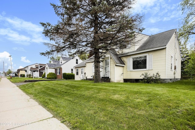 1834 Western Ave, Guilderland, NY 12203 - view of side of home with entry steps, a lawn, a shingled roof, and a residential view