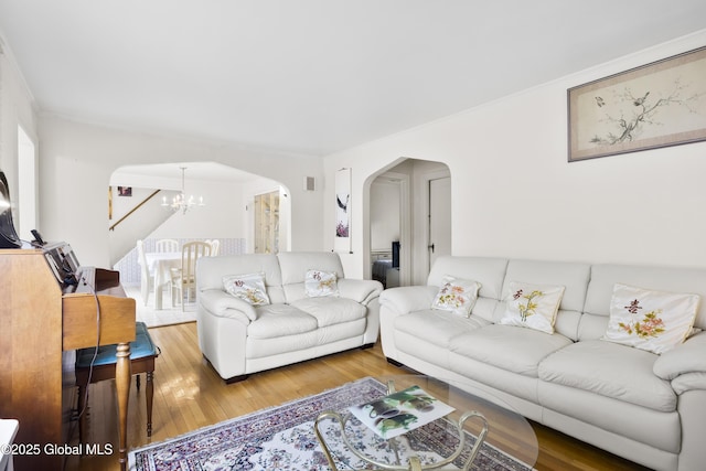 1834 Western Ave, Guilderland, NY 12203 - living area with arched walkways, a chandelier, and wood finished floors