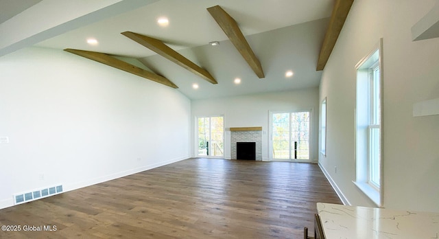 unfurnished living room featuring beam ceiling, a fireplace, dark wood-style floors, high vaulted ceiling, and recessed lighting