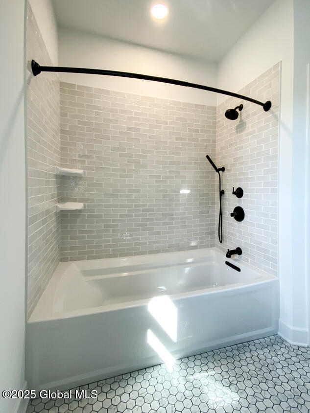 bathroom featuring bathtub / shower combination and tile patterned floors