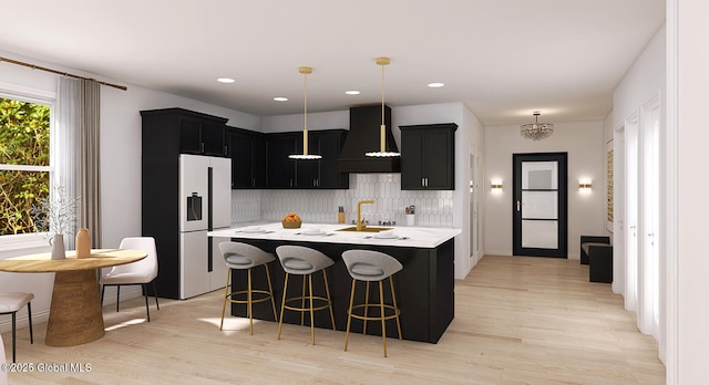 kitchen featuring custom exhaust hood, light countertops, dark cabinetry, fridge with ice dispenser, and decorative backsplash