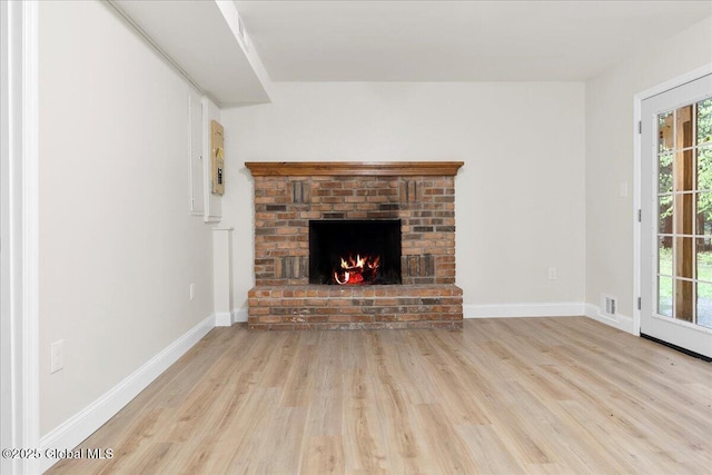 292 Stone Church Rd, Ballston Spa, NY 12020 - unfurnished living room with wood finished floors, a fireplace, and baseboards