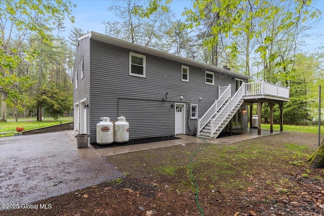 292 Stone Church Rd, Ballston Spa, NY 12020 - rear view of house with stairway, driveway, a wooden deck, and a garage