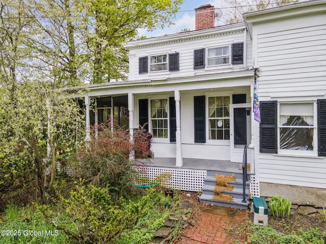 12098 Duanesburg Rd, Duanesburg, NY 12053 - view of front of house with a chimney and covered porch