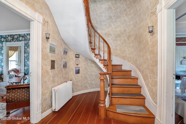 12098 Duanesburg Rd, Duanesburg, NY 12053 - stairs featuring wallpapered walls, wood-type flooring, radiator heating unit, baseboards, and ornamental molding