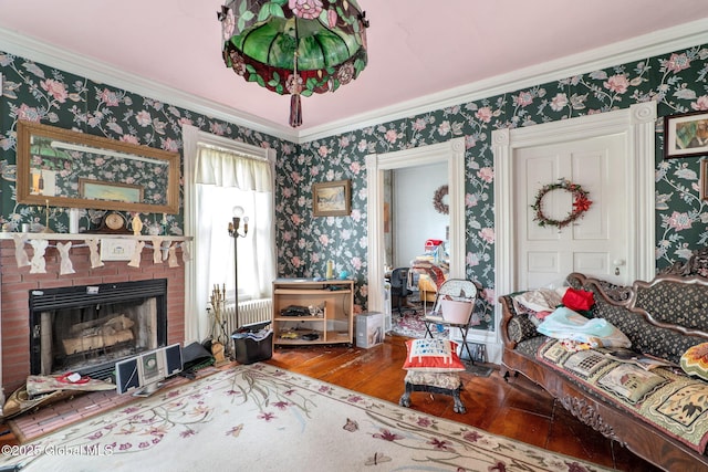 12098 Duanesburg Rd, Duanesburg, NY 12053 - living room with wood-type flooring, wallpapered walls, crown molding, a brick fireplace, and radiator