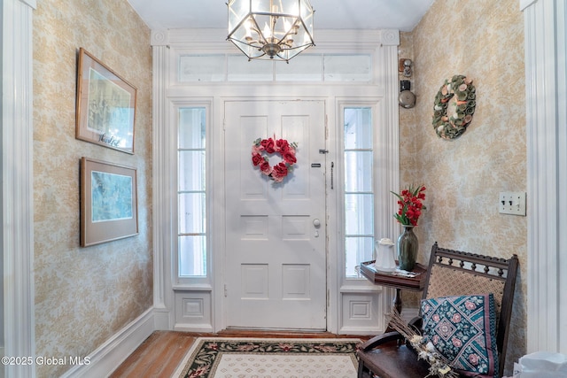 12098 Duanesburg Rd, Duanesburg, NY 12053 - entrance foyer featuring wood finished floors, wallpapered walls, and a chandelier