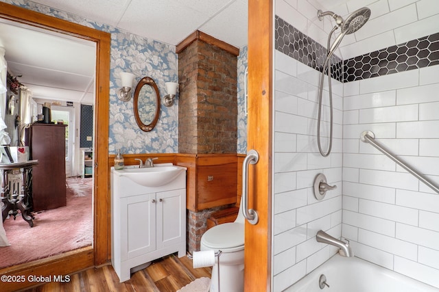 12098 Duanesburg Rd, Duanesburg, NY 12053 - bathroom featuring wood finished floors, a wainscoted wall, tub / shower combination, vanity, and toilet