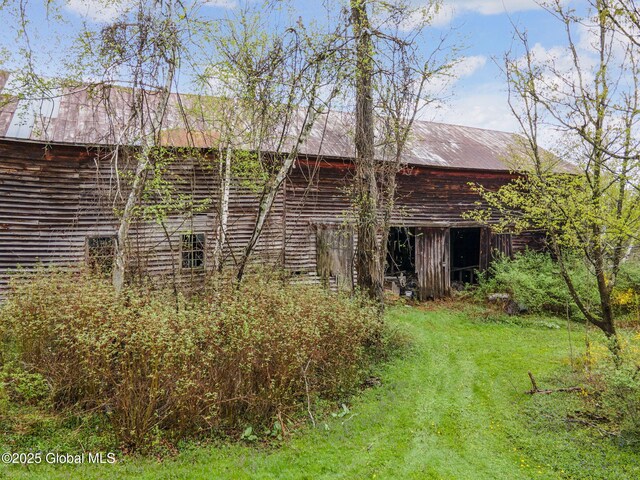 12098 Duanesburg Rd, Duanesburg, NY 12053 - back of property featuring a barn, an outdoor structure, a lawn, and metal roof