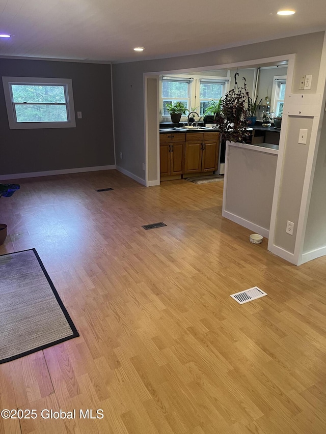 434 Old Stage Rd, Lake Luzerne, NY 12846 - unfurnished living room with baseboards, healthy amount of natural light, light wood-style flooring, and recessed lighting