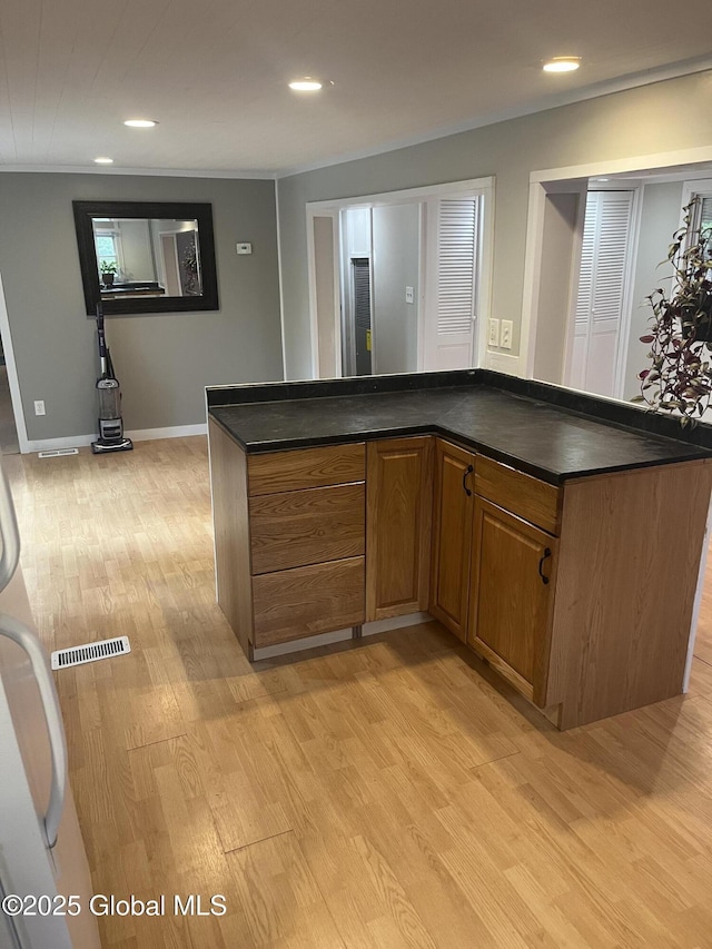 434 Old Stage Rd, Lake Luzerne, NY 12846 - kitchen featuring dark countertops, light wood-style floors, brown cabinetry, recessed lighting, and baseboards