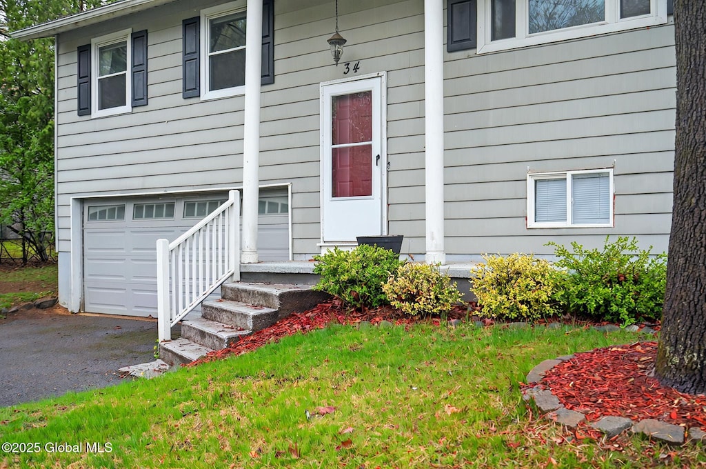 34 Orenda Spring Dr, Saratoga Springs, Inside, NY 12866 - property entrance with an attached garage, driveway, and a yard