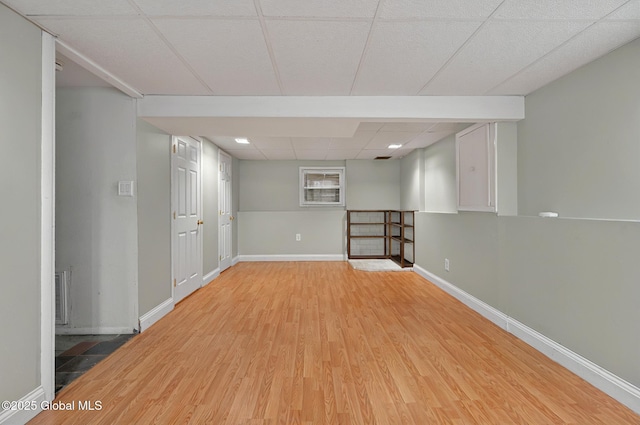 finished basement with light wood-style flooring and baseboards