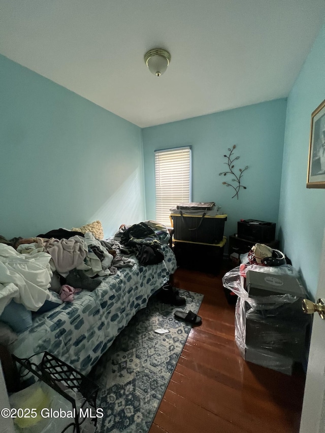 bedroom with dark wood-style floors